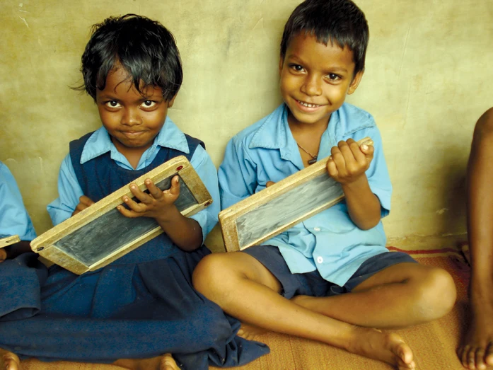 smiling kids learning in a school supported by care for children