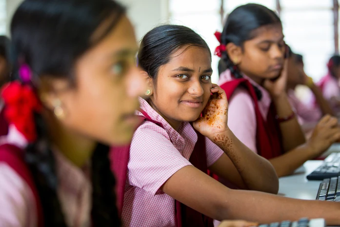 smiling girl child learning in a classroom