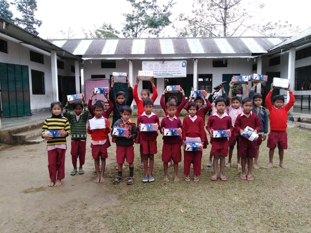 Shoes distribution to kids from 97 schools