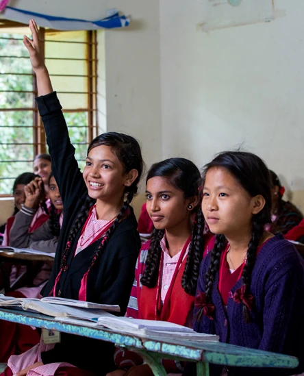 Smiling girl participating in a classroom discussion