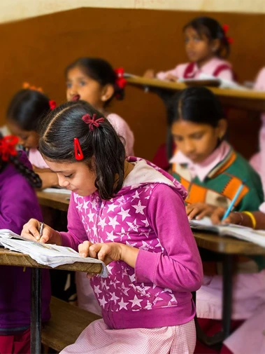 Girl child writing in class